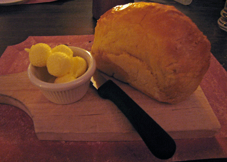 A loaf of homemade bread with butter