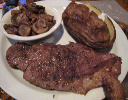 A twelve-ounce New York Strip with sauteed mushrooms and a baked potato