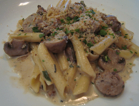 Fontina cheese Pasta with sage, chicken sausage, cherries, herbs and port wine topped with bread crumbs.