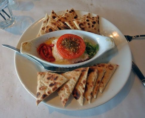 Feta Psiti: Baked Feta with peppers, tomato & olive oil; Served with pita wedges