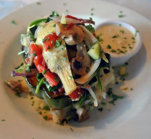 Stuffed Acorn Squash: Spinach, fennel, cherry tomatoes, artichoke hearts, asparagus & mushrooms served with garlic mashed potatoes & topped with dill cream-sauce