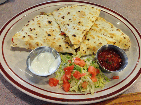 Smoked Turkey Quesadilla: Two large tortillas filled with grilled smoked turkey breast, sautéed green chile, mushrooms and diced onions and melted cheese. Served with sour cream, salsa, lettuce and tomato.