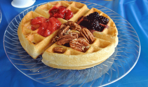 Waffle topped with fruit and pecans