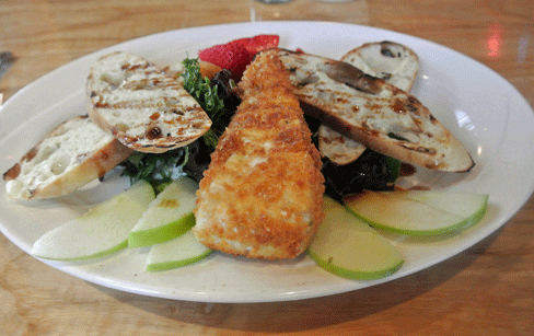Fried Brie crispy brie cheese, apples strawberries, mixed greens, grilled baguette, pomegranate glaze